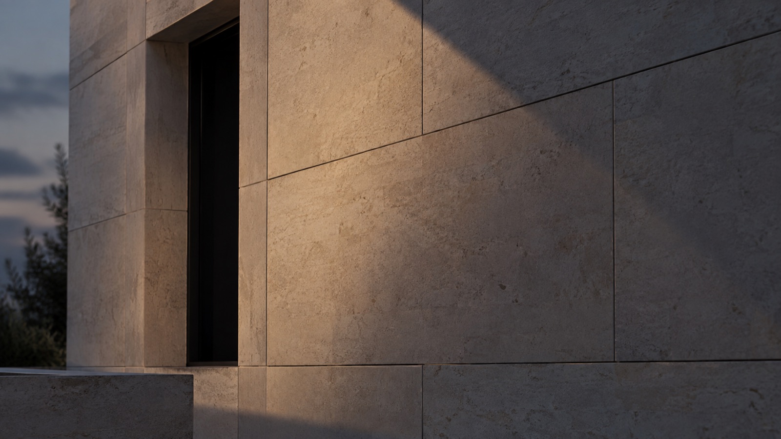 A stone facade in flat evening light, shadow across the elevation